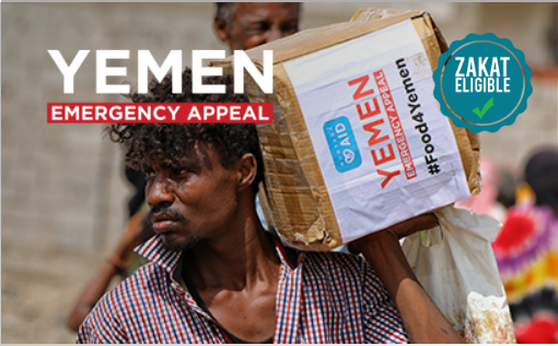 A person carrying a box with the text 'YEMEN EMERGENCY APPEAL' and 'ZAKAT ELIGIBLE' on the image